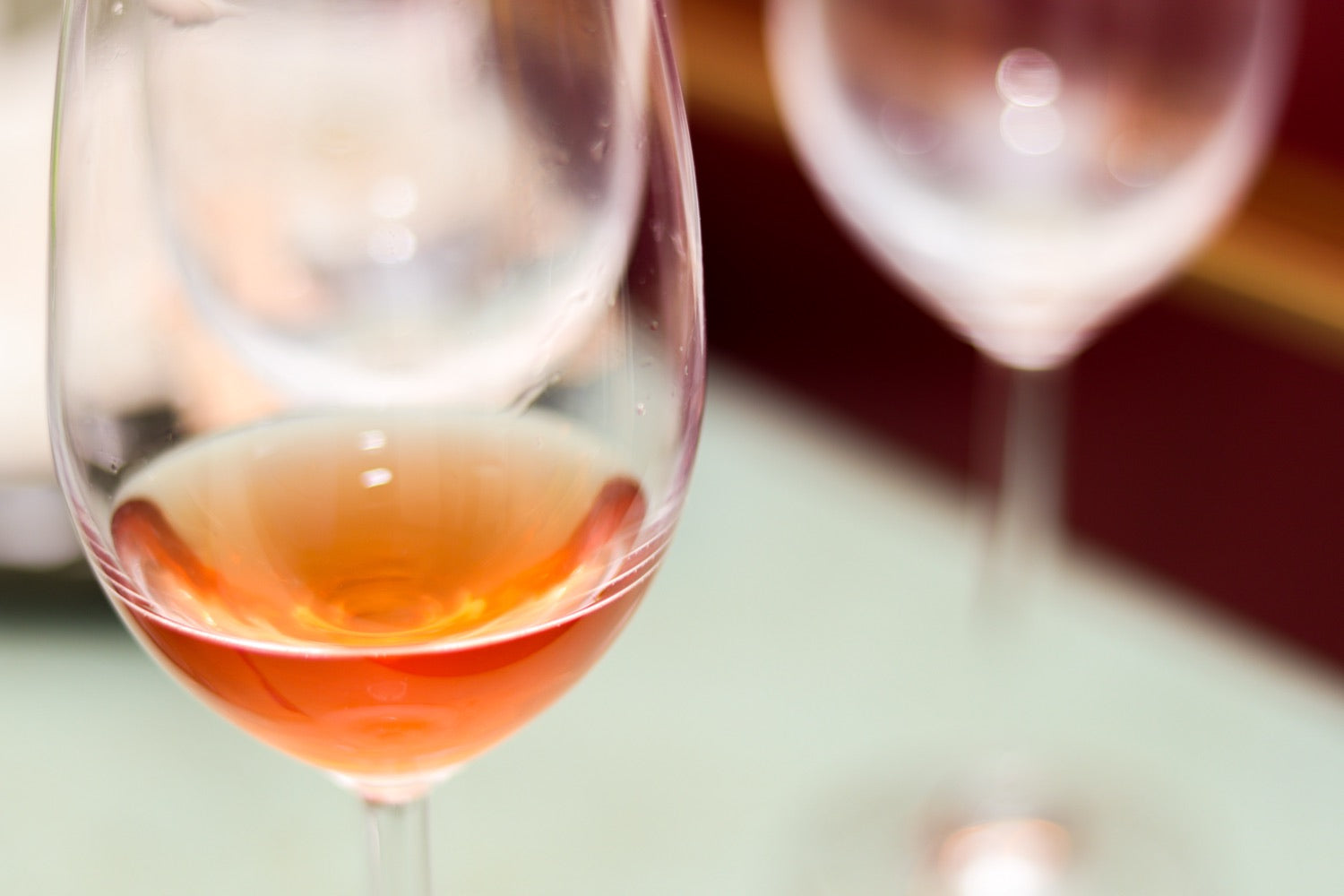 A glass of amber wine catching the candlelight