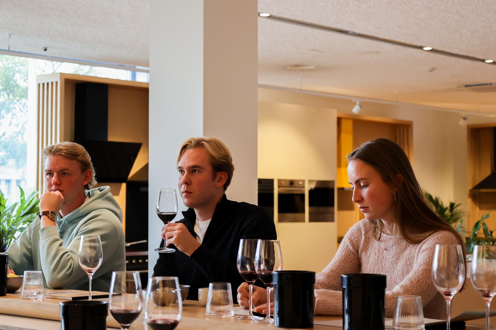 Colleagues tasting red wine together during a daytime corporate tasting